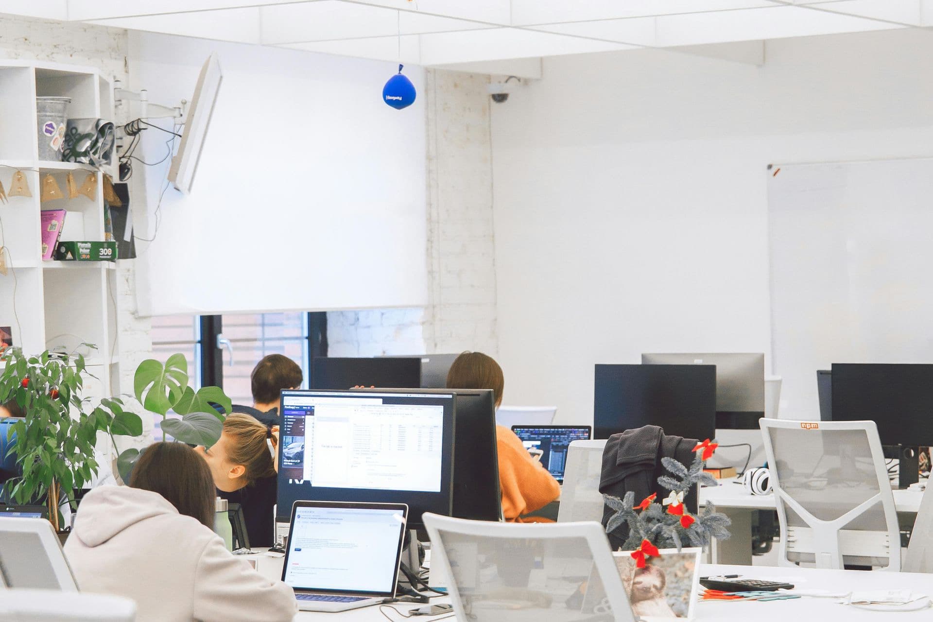 A team working at computers in a modern technology office.